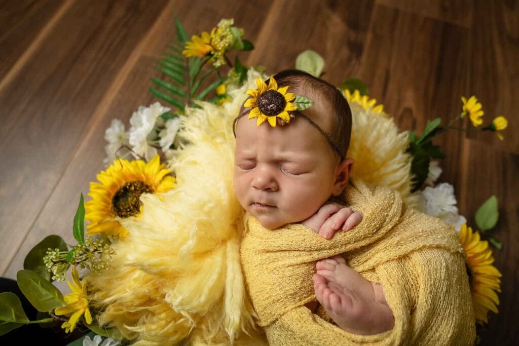 Vale of Glamorgan Newborn Photographer, newborn baby in a sunflower wreath prop